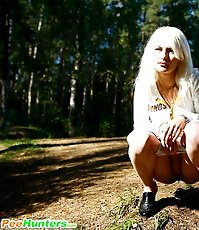 Shameless young blonde tart caught peeing on forest path