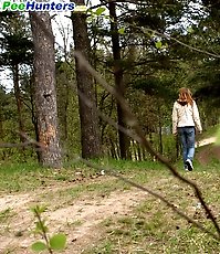 Cute kitty gets spycammed while peeing in the bushes