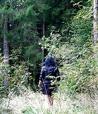 Naughty brunette pisses into a sandpit in forest