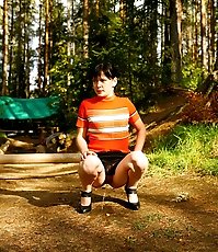 Careless puss peeing on a beautiful forest glade