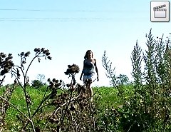 Blonde shortie with big boobs makes water outdoors