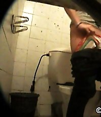 Hot babe emptying her bladder in public toilet