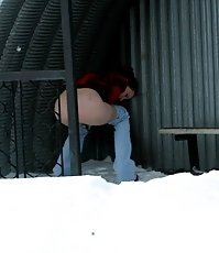 Winter shooting of a girl making water in the park