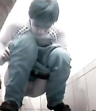 Raunchy hottie urinates onto spy cam in public loo