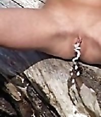 Kinky tart pisses in the middle of a nudist beach