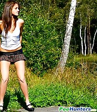 Cute young chick in checkered mini pisses outdoors