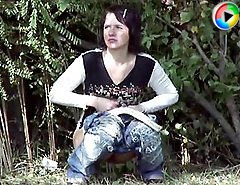 Voyeur movies of a cute chick doing a pee in the bushes