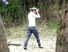 Slim teenage nudist chick caught peeing in bush