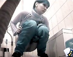 Raunchy hottie urinates onto spy cam in public loo