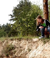Beautiful teen plays watersports on a quiet forest glade