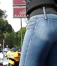 Tight blue jeans on firm butt cheeks